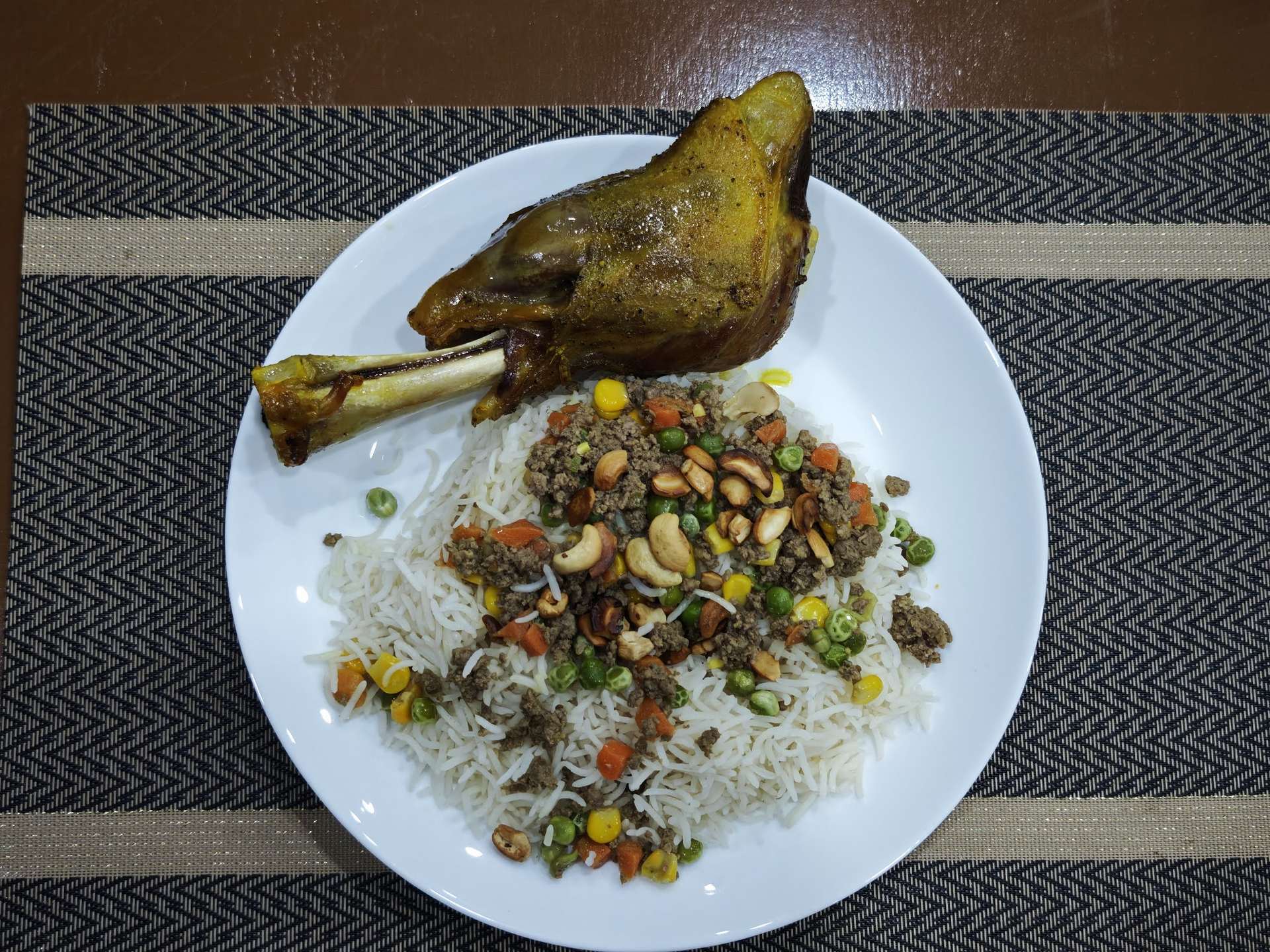 Palestinian ozi lamb shank served over spiced rice with minced meat and nuts